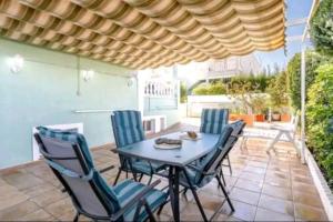 a table and chairs sitting on a patio at Bungalow adaptado, terraza muy grande y soleada. in Gran Alacant
