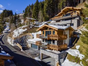 an aerial view of a resort building with snow at Haus am Hang in Saalbach-Hinterglemm