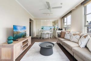 a living room with a couch and a table at Harbourside #53 in Sydney