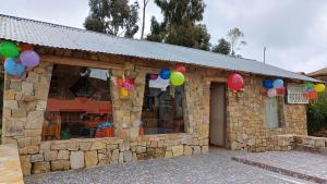 a stone building with balloons attached to it at Wara Uta Lodge in Comunidad Yumani