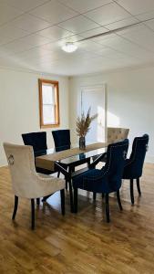 a dining room with a table and chairs at Tranquil Coastal Escape in Port Stanley