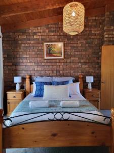 una camera con un letto con un muro di mattoni di Ocean Breeze - Foodies Delight - Scamander a Scamander
