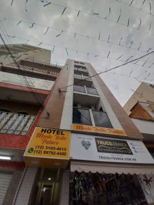 a building with signs on the side of it at Hotel Monte Belo Palace in Aparecida