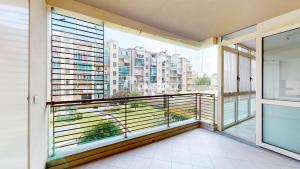 a balcony with a view of a city at Topazio Apartment; pratico, moderno e signorile! in Turin