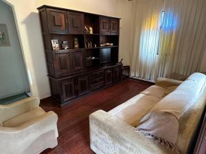 a living room with a couch and a television at Casa no campo in Bom Jardim