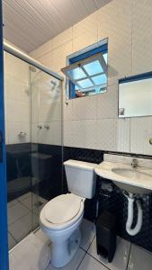 a bathroom with a toilet and a shower and a sink at Escadaria Vila Rica Pousada & Hostel in Ouro Preto +62 photos