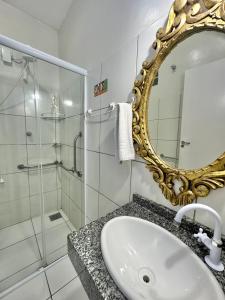 a bathroom with a sink and a mirror at Hotel Aeroporto Montese Star in Fortaleza