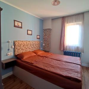 a bedroom with a large bed with a window at 9 Doors in Tbilisi City