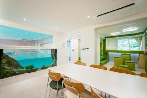 an office with a table and chairs and an aquarium at Pico Kids Pool Villa in Busan