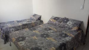 um quarto com uma cama e um sofá com um cobertor em Casa Beira Mar - Praia Icaraí - CE em Caucaia