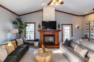 a living room with a couch and a fireplace at Hillside Villa Ohio in Millersburg