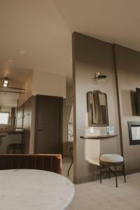 a room with a table and a mirror on the wall at The Atlee Suites in Millersburg