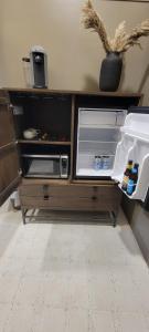 an open refrigerator in a kitchen with its door open at The Atlee Suites in Millersburg