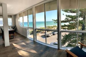 a living room with a view of the ocean at Ultimate Coastal Escape + Amazing Views in Caloundra