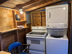 a kitchen with a stove and a microwave at EcoCottage Private Hot Tub in Union