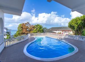 a swimming pool on a balcony of a house at Villa Amore Jamaica - Between Montego Bay & Ochi Rios Includes Cook in Discovery Bay