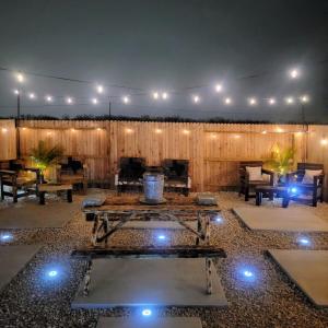 a patio with a table with lights on it at RJ's Retreats in Von Ormy