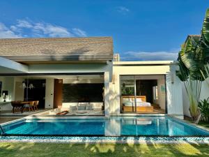 a swimming pool in front of a house at Villa Amata in Phuket