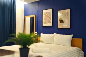 um quarto com uma parede azul e uma cama em The View Residence em Banguecoque