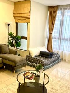 a living room with a couch and a table at Bali Residence PROMO PRICE W#APP NO BELOW in Malacca