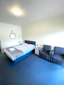 1 dormitorio con 1 cama, 1 sofá y 1 silla en Ballarat Colonial Motor Inn, en Ballarat