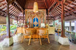 een eetkamer met een tafel en stoelen bij Meruhdani Boutique Hotel Ubud in Ubud