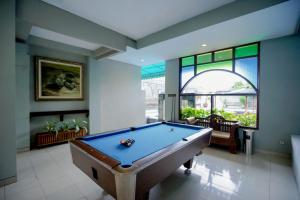 a pool table in a room with a window at Cakra Kusuma Hotel in Yogyakarta