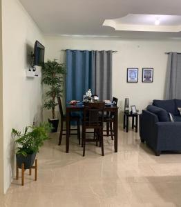 a living room with a table and a couch at The Blue Moroccan Door - A modern 3 bedroom,2 bathroom home 