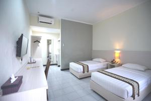 Krevet ili kreveti u jedinici u okviru objekta Cakra Kusuma Hotel