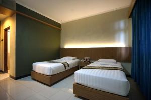 Krevet ili kreveti u jedinici u okviru objekta Cakra Kusuma Hotel