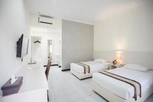 Krevet ili kreveti u jedinici u okviru objekta Cakra Kusuma Hotel