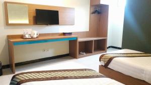 Krevet ili kreveti u jedinici u okviru objekta Cakra Kusuma Hotel