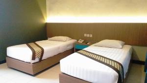 Krevet ili kreveti u jedinici u okviru objekta Cakra Kusuma Hotel