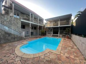 a swimming pool in the courtyard of a building at Le Muguet by EGL IMMO in Saint-Pierre