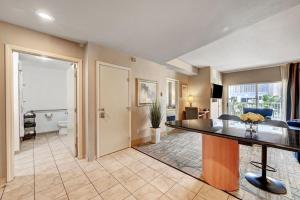 a living room with a dining table and a living room at Royal Oasis Suite at Platinum Hotel-Strip Views in Las Vegas