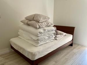 uma pilha de almofadas em cima de uma cama em 1日1組限定　和洋折衷 EDOYA em Chiba