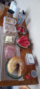 a table topped with plates of food and a bagel at Hostel Santa Luzia in Viçosa