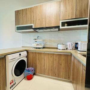 a kitchen with a washer and dryer on the counter at Forest city Sea view homestay in Gelang Patah