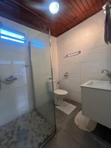 a bathroom with a shower and a toilet and a sink at Le Jasmin by EGL IMMO in Saint-Pierre