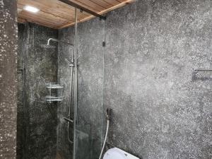 a bathroom with a glass shower with a toilet at CHILCHILL Elite Residences BKK2 in Phnom Penh