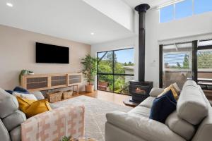 a living room with a couch and a fire place at 153 Centenary Heights Rd in Yaroomba