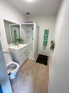 a bathroom with a toilet and a sink at Double Bedroom with Private Bathroom in Porirua