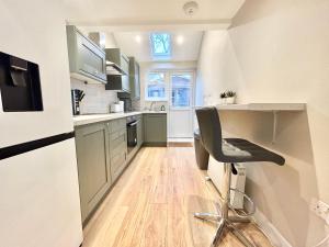 a kitchen with a desk and a chair in it at The Keyfield House - St Albans in St. Albans