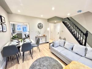 a living room with a couch and a table at The Keyfield House - St Albans in St. Albans