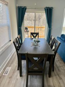 a dining table and chairs in a room with a window at NEW Luxury Home Downtown Pet Friendly Fenced Yard in Chattanooga