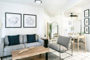 a living room with a couch and a table at Sea View & Sunset Haven in Enighed