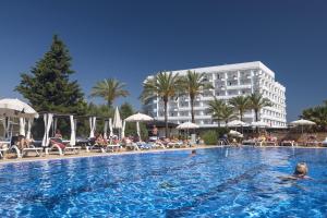 a large swimming pool in front of a hotel at Cala Millor Garden Hotel - Adults Only in Cala Millor
