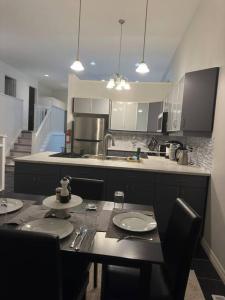 a kitchen with a table and chairs and a counter top at Luxury Spacious 5-Bedroom Home in London