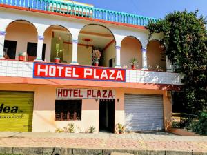 a hotel plaza with a hotel plaza sign on a building at Hotel Plaza_Khajuraho in Khajurāho