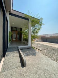 a building with a bench in front of a building at HAKKA Wellness Residence in Samut Songkhram